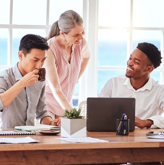 strategic-web-design-milton-brisbane-oceansky Three digital marketing professionals in a Milton office discussing responsive web design and local SEO growth.