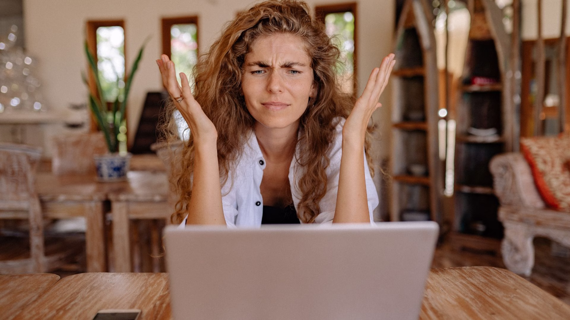 A Brisbane small business owner looking frustrated at a laptop screen asking why is my business not showing on Google search results — OceanSky Digital